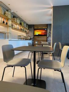 a dining room with a table and chairs at Iris Hotel in Erbusco