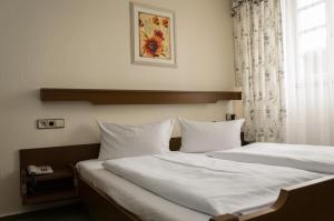 Postel nebo postele na pokoji v ubytování Hotel Rheingraf