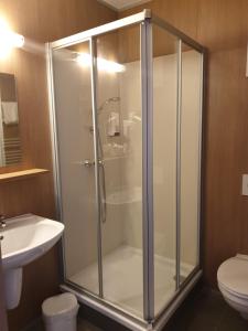 a bathroom with a shower stall and a toilet at FairSleep Motel Hainburg in Hainburg an der Donau