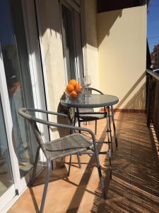 a table and chairs on a balcony with oranges on it at Cosy flat with excellent location in Valencia! in Valencia