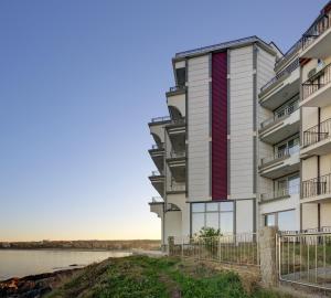 an apartment building with a view of the water at HARMONY in Sozopol +49 photos