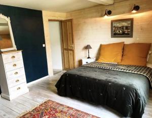 a bedroom with a bed and a dresser and a rug at La Cour Sainte Catherine demeure de charme in Honfleur