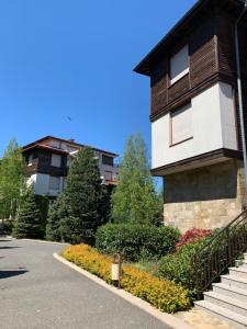 a house with a staircase next to a driveway at Santa Marina Apartment 513 in Sozopol +18 photos