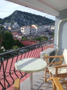 a balcony with a table and chairs and a view at InStyle Zakynthos town Apartment in Zakynthos