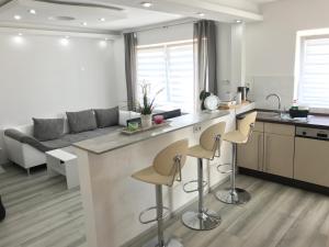 a kitchen with a large island with bar stools at Aparts House - Balkon - Free Parking- WiFi - Kitchen in Essen