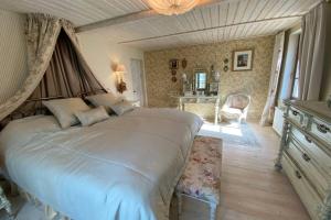 a bedroom with a large bed in a room at Beach House Ežurgas in Tūja