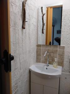 a bathroom with a sink and a mirror at Comfortable Home Ermoupolis in Ermoupoli