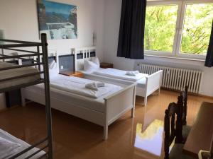 a bedroom with two beds and a bunk bed at GZ Hostel Bonn in Bonn