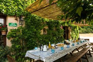 a long table with food and drinks on it at Gîte de Vénascle in Moustiers-Sainte-Marie