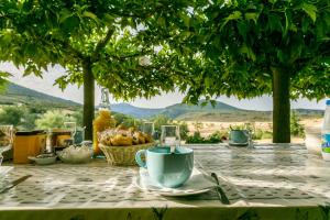 a table with a table cloth with a tea cup on it at Gîte de Vénascle in Moustiers-Sainte-Marie