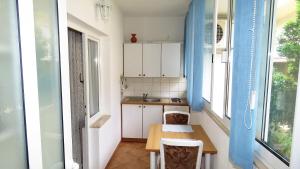a small kitchen with a table and two chairs at Apartments Milena & Ante in Makarska