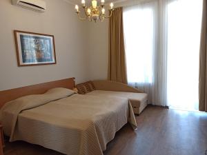 a bedroom with two beds and a chandelier at Апартаменты Sampo in Vyborg