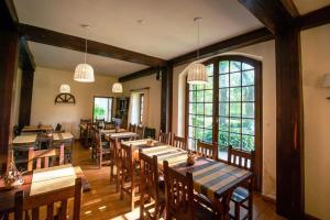 a restaurant with wooden tables and chairs and windows at Hotel Apartur Mar del Plata in Mar del Plata