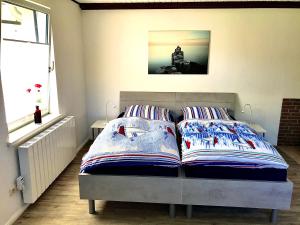 Un pat sau paturi într-o cameră la Ferienhaus Till & Lotte