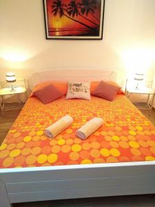 a bed with two pillows on top of it at Apartments Green & Orange in Hvar