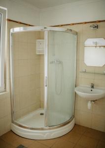 a bathroom with a shower and a sink at MARMAT Łeba in Łeba