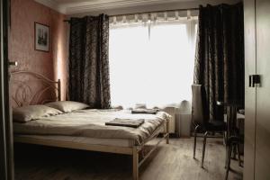 a bedroom with a bed in front of a window at MARMAT Łeba in Łeba