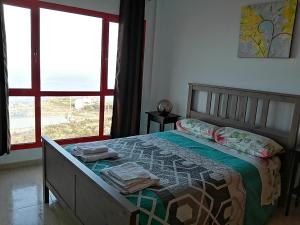 a bedroom with a bed with a view of the ocean at Buena Vida in Breña Baja