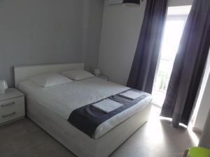 Postel nebo postele na pokoji v ubytování Apartmani Lara