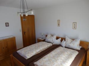 two beds sitting in a room with at Landhaus Sommerau in Reith bei Kitzbühel