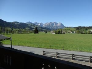 einen Blick auf ein Feld mit Bergen im Hintergrund in der Unterkunft Landhaus Sommerau in Reith bei Kitzbühel