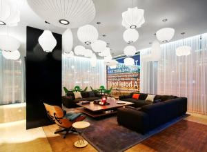 a living room filled with furniture and a large window at citizenM Schiphol Airport in Schiphol