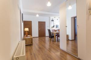 a living room with a table and a dining room at Fogra Travel Apartment in Krakow