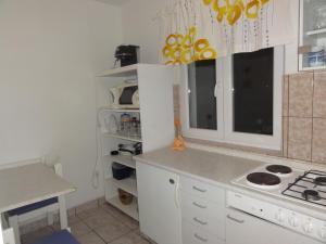 a kitchen with white cabinets and a counter top at Apartmani Anka in Gradac