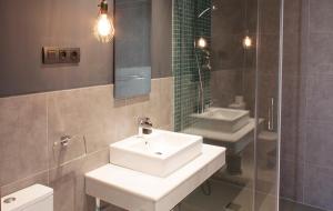 a bathroom with a white sink and a mirror at Apartamentos NONO by Charming Stay in Málaga