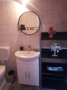 a bathroom with a sink and a mirror at Apartment Ane in Bale