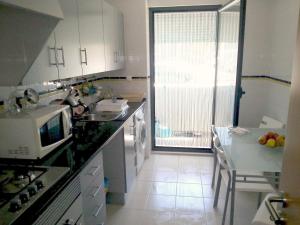 a kitchen with a sink and a counter top at Isis & Isa in Monte Gordo