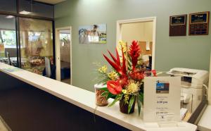 a counter with a vase of flowers on it at Royal Kuhio Resort in Honolulu