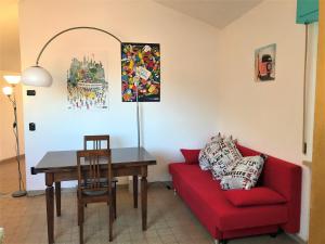 a living room with a red couch and a table at Stella Apartments in Malcesine