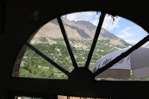 a view of a mountain through a window at Fort View Guest House in Baltit