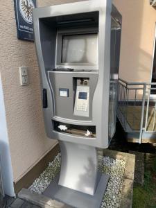 a pay phone sitting on the side of a building at Residenz Hotel Giessen in Gießen
