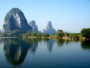 a large body of water with mountains in the background at 7Days Inn Guilin Qixing Road in Guilin