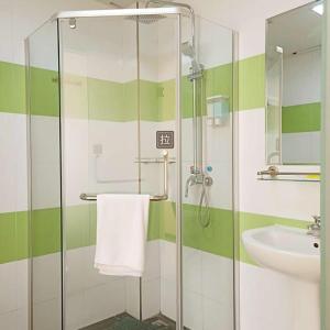 a bathroom with a glass shower and a sink at 7Days Inn Jinchang Culture Street in Pai-chia-tsui