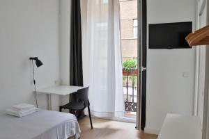 Postel nebo postele na pokoji v ubytování Hostal La Zona