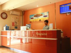 a man standing at the counter of adqán store at 7Days Inn Shangqiu democratic road WAL-MART in Shangqiu