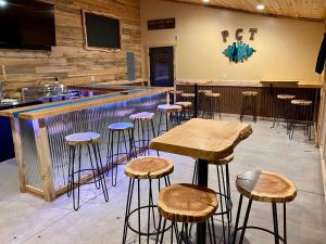a bar with wooden stools in a room at Black Elk Resort in Hill City