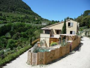 a house on the side of a mountain at Le Mille Fleurs in Aubres