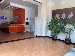 an empty lobby with a waiting room with plants at 7Days Inn Shijiazhuang Friendship Avenue Jianguo Road in Shijiazhuang