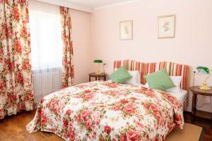 a bedroom with a bed with a floral bedspread at Hotel Krone Laupheim in Laupheim