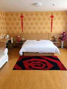 a bedroom with a bed with a rug on the floor at 7Days Inn Jixian County Road in Shuangyashan