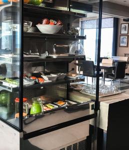 a kitchen filled with lots of food on shelves at Hotel Nais Beach in Durrës