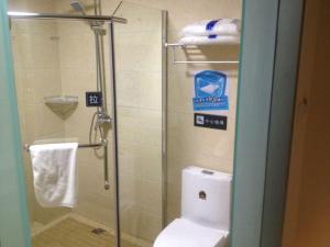 a bathroom with a toilet and a glass shower stall at 7Days Inn Huaian vehicle administration in Huai'an