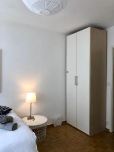 a bedroom with a bed and a white cabinet at The Paquis Oasis in Central Geneva in Geneva