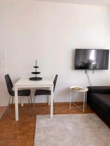 a living room with a white table and a couch at The Paquis Oasis in Central Geneva in Geneva