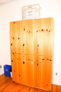 a wooden locker with a sign on top of it at Auberge L'Apero in Montreal