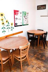 two wooden tables and chairs in a room at Auberge L'Apero in Montreal